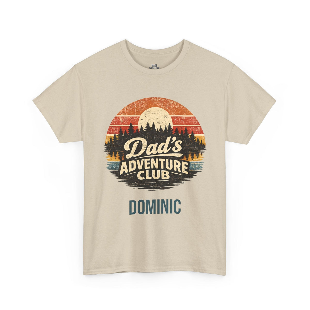A beige crewneck t-shirt featuring a retro circular graphic with a sunset landscape and the text 'Dad's Adventure Club' above the name 'DOMINIC' printed in blue.