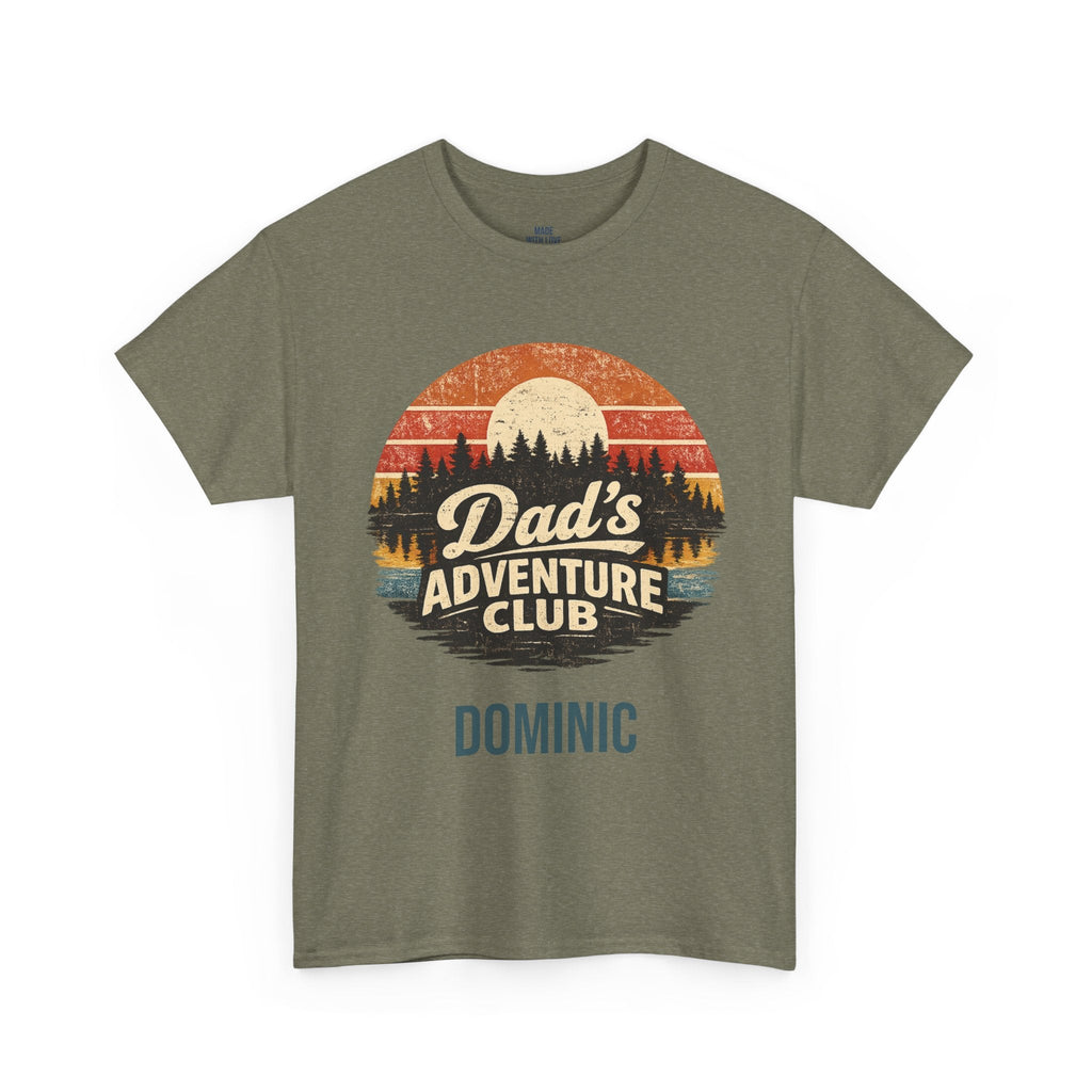 An olive green crewneck t-shirt featuring a retro circular graphic with a sunset, pine trees, and the text 'Dad's Adventure Club' with 'DOMINIC' printed below in blue.