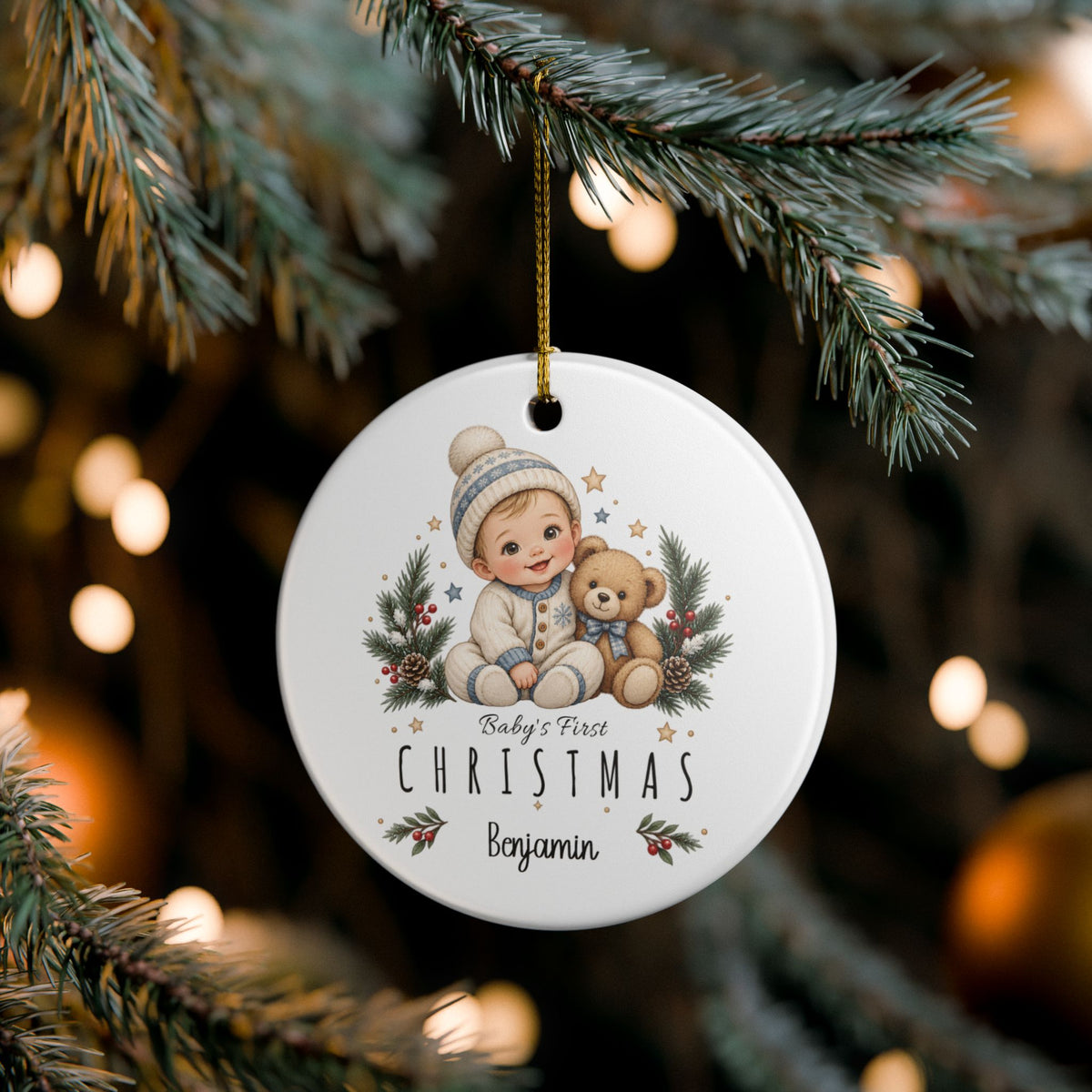 Baby Boy First Christmas ornament hanging on a lit Christmas tree, lifestyle photo
