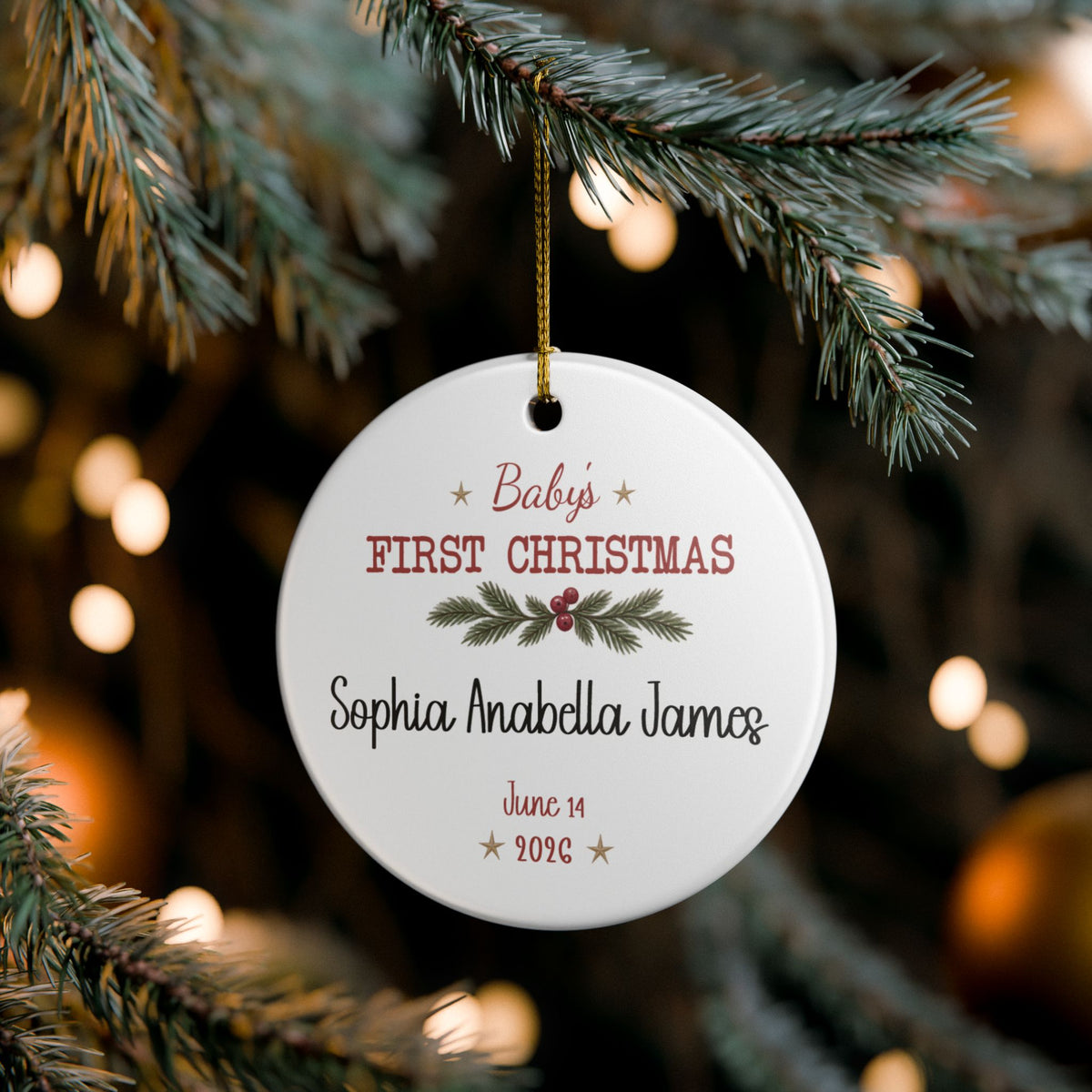 Baby's First Christmas Keepsake ornament hanging on a lit Christmas tree, lifestyle photo