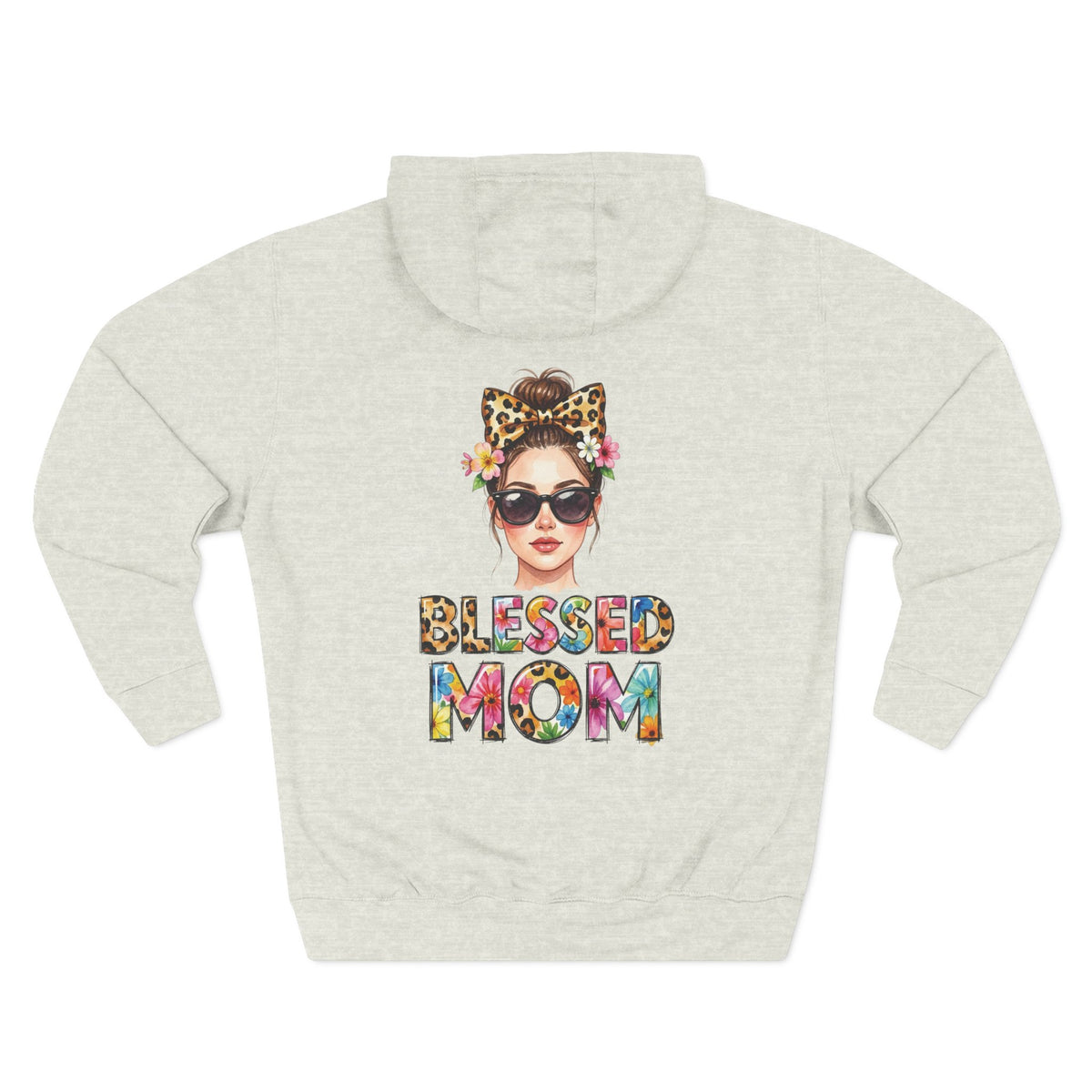 A light oatmeal heather hoodie shown from the back, featuring a colorful graphic of a woman with sunglasses, a leopard-print bow headband, and flowers, with the text 'BLESSED MOM' in a multicolor tie-dye pattern below. For mom.