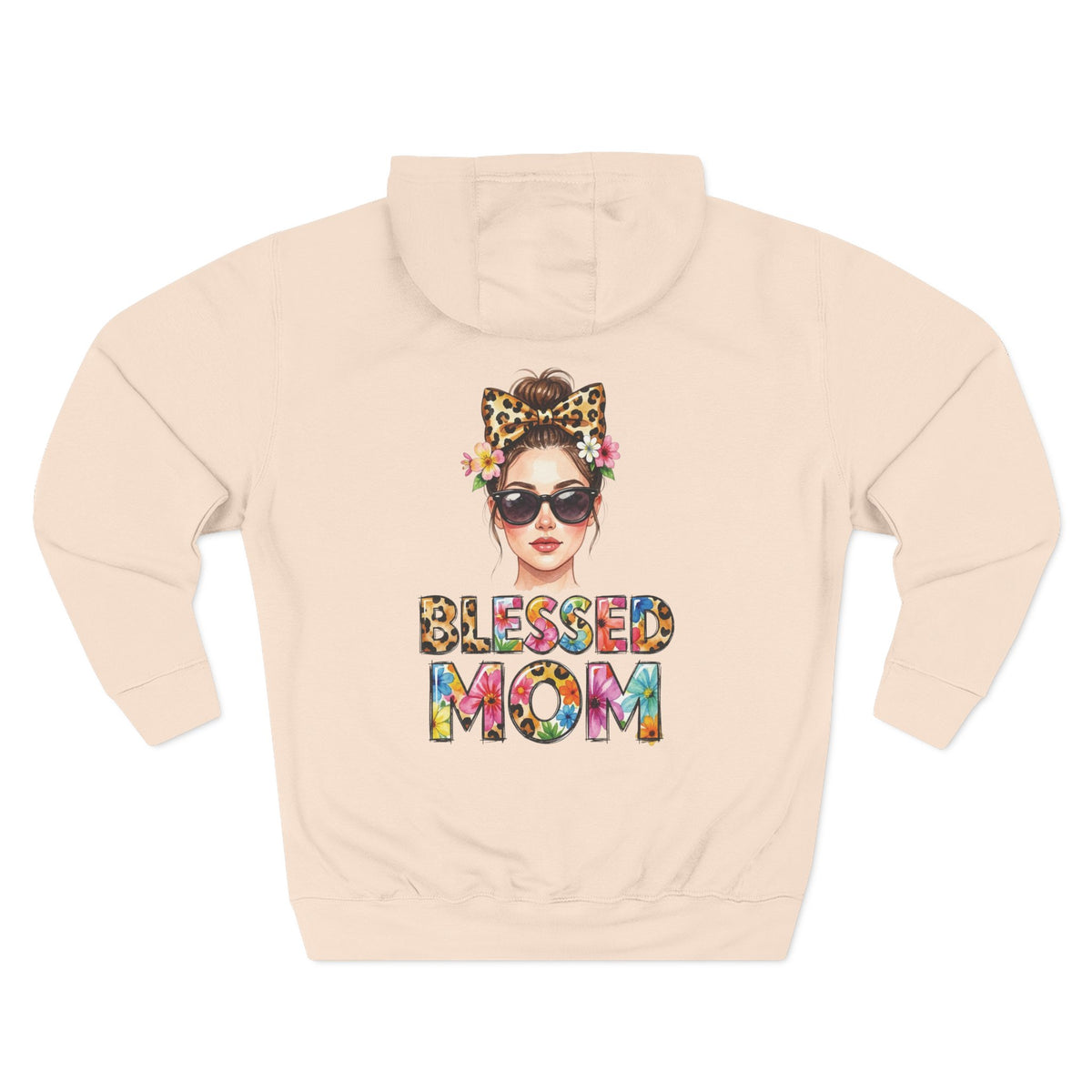 A light pale pink hoodie shown from the back, featuring a colorful graphic of a woman with sunglasses, a leopard-print bow headband, and flowers, with the text 'BLESSED MOM' in a multicolor tie-dye pattern below. For mom.