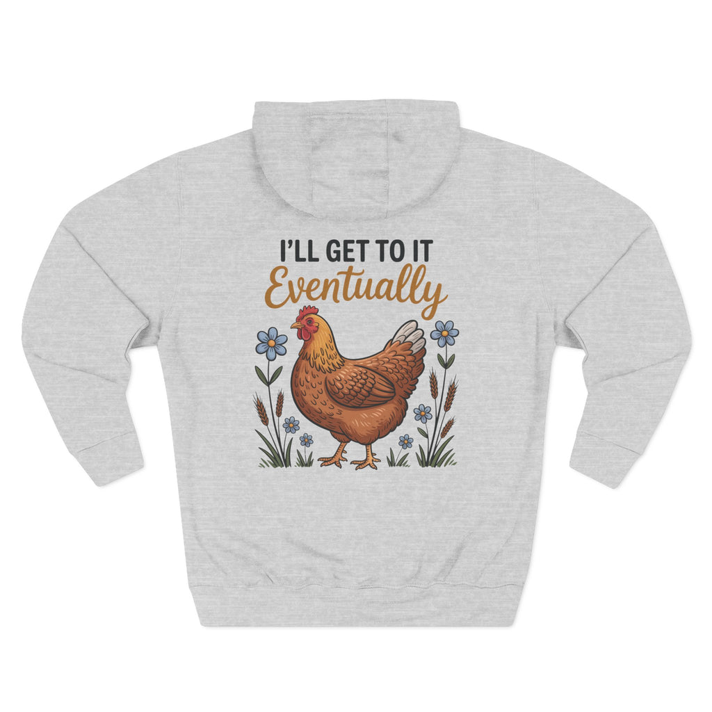 A light heather gray pullover hoodie shown from the back, featuring a graphic print of a brown chicken surrounded by small blue flowers and the text 'I'LL GET TO IT Eventually' in black and brown lettering.