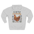 A light heather gray pullover hoodie shown from the back, featuring a graphic print of a brown chicken surrounded by small blue flowers and the text 'I'LL GET TO IT Eventually' in black and brown lettering.