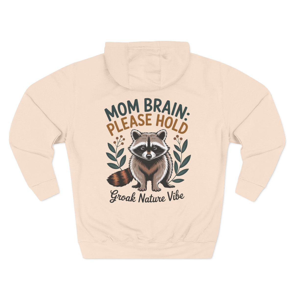 A pale pink hoodie shown from the back, featuring a graphic of a raccoon with the text 'MOM BRAIN: PLEASE HOLD' and 'Groak Nature Vibe' in green, orange, and dark gray lettering. For mom.