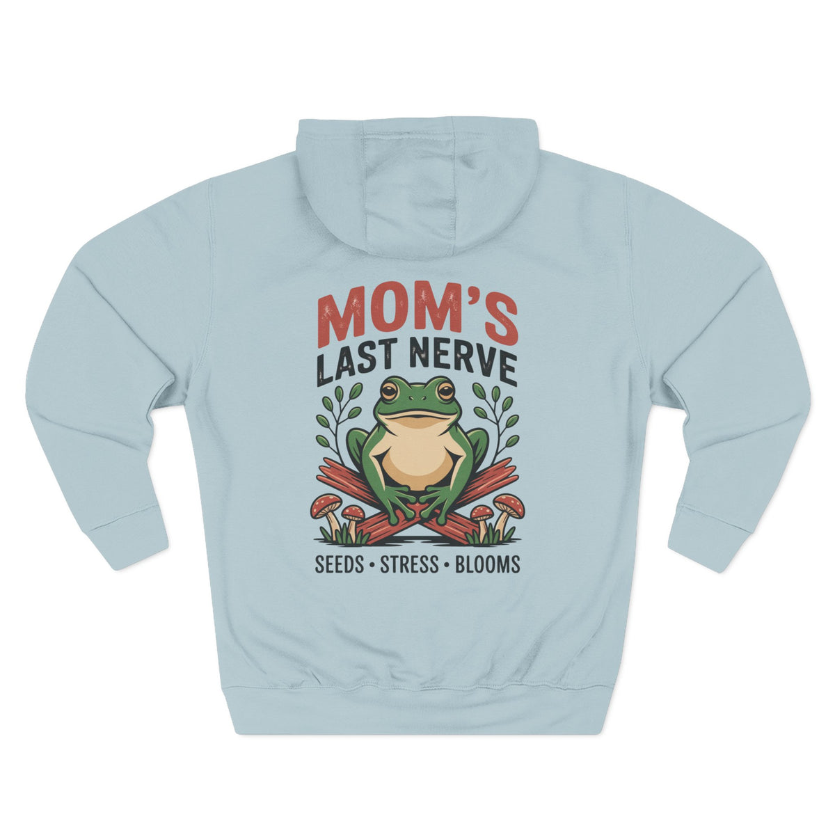 A light blue mist hoodie shown from the back, for Mom, featuring a graphic print of a green frog sitting on red mushrooms with the text 'MOM'S LAST NERVE' and 'SEEDS * STRESS * BLOOMS'.