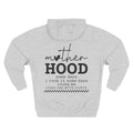 A light grey heather pullover hoodie shown from the back, featuring a black graphic print that reads 'mother HOOD' with a heart replacing the letter 'o' in 'mother', followed by the phrase 'some days i rock it some days rocks me other way we're rockin' with a small checkered line at the bottom. Special gift for mom