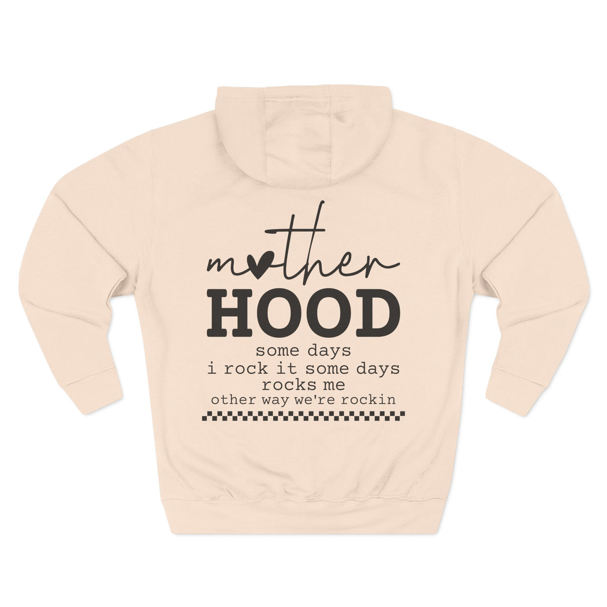 A pale pink pullover hoodie shown from the back, featuring a black graphic print that reads 'mother HOOD' with a heart replacing the letter 'o' in 'mother', followed by the phrase 'some days i rock it some days rocks me other way we're rockin' with a small checkered line at the bottom. Special gift for mom