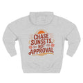 Back view of heather grey hoodie with “Chase Sunsets, Not Approval” design