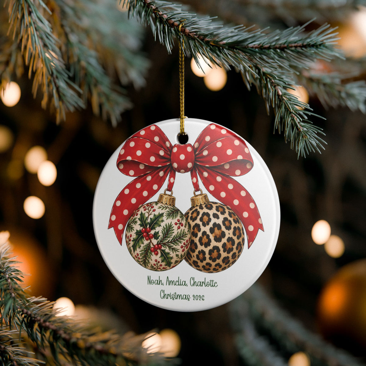 Christmas Bow & Baubles ornament hanging on a lit Christmas tree, lifestyle photo