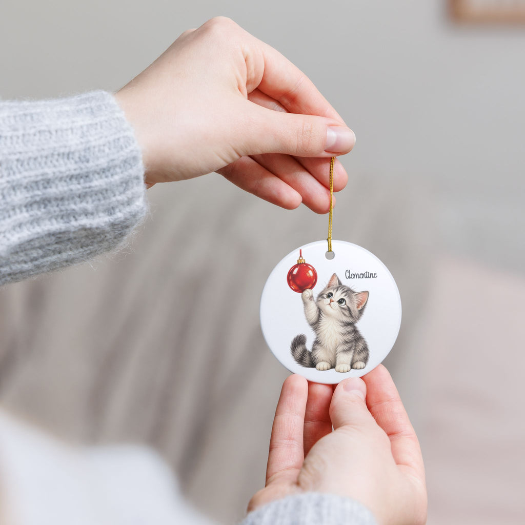 Hands holding the personalized Christmas Kitten ornament to show its size