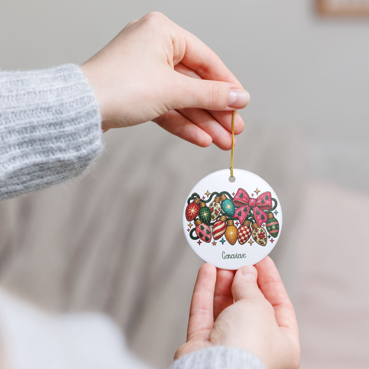Hand holding the personalized Colorful Christmas Lights ornament by its gold string