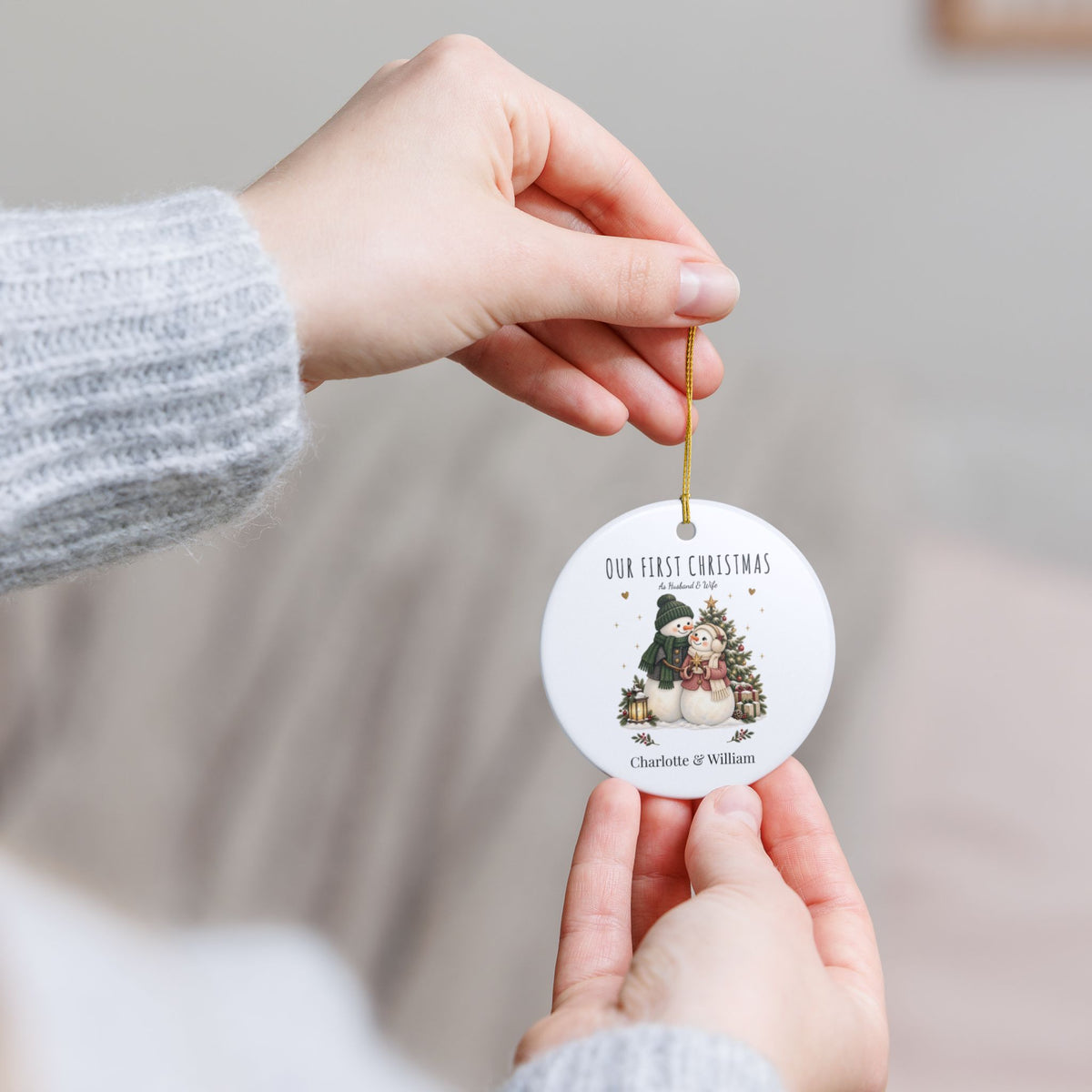 Hands holding the personalized Our First Christmas as Husband & Wife ornament to show its size
