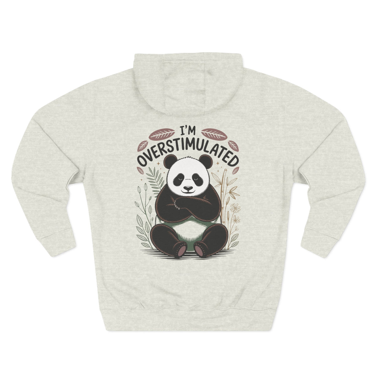 A oatmeal heather long-sleeve hoodie with a graphic of a panda sitting in the center, surrounded by the text 'I'M OVERSTIMULATED' and small botanical illustrations. For her or for Mom