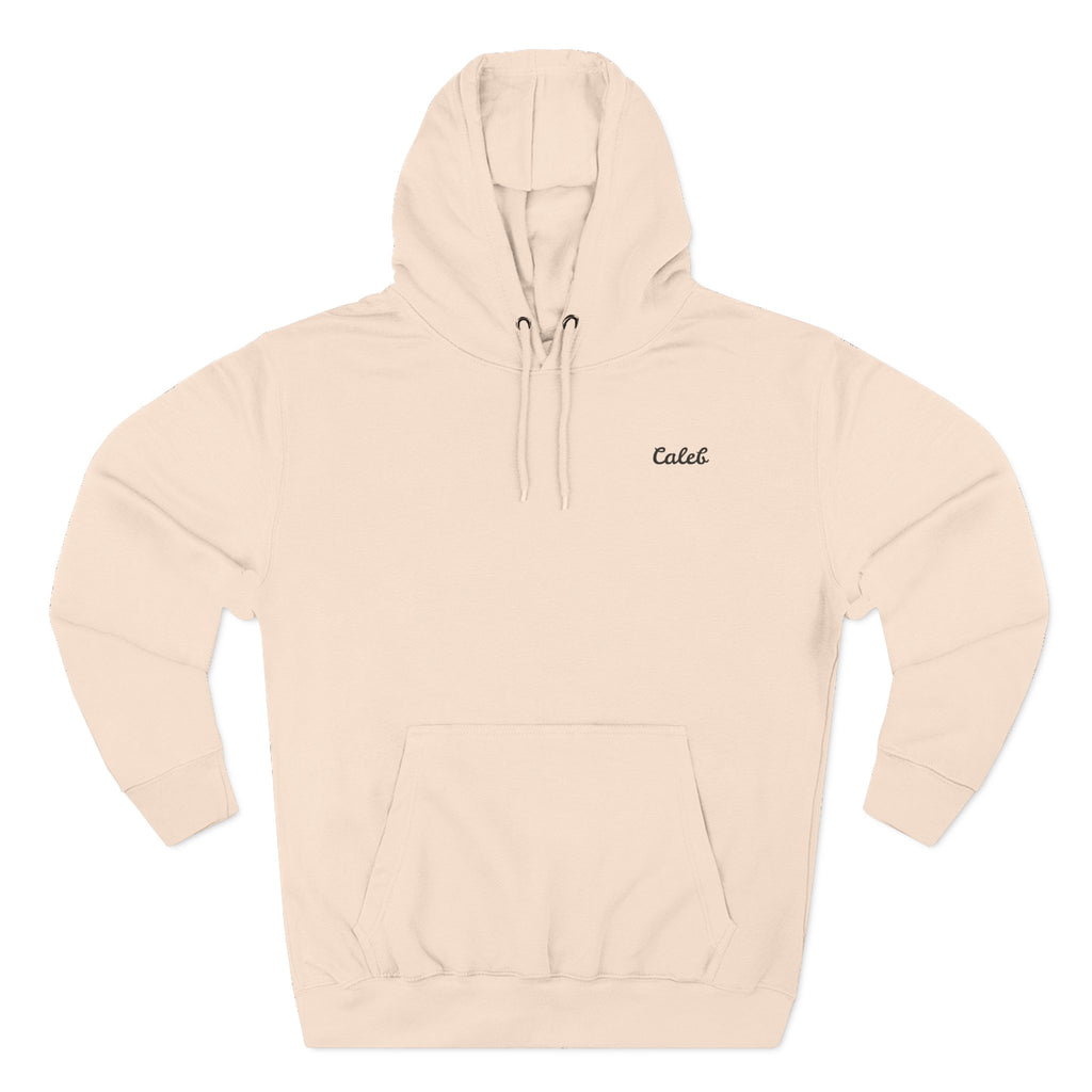 Front view of a pale pink personalized hoodie printed with "My First Hero, My Dad" and embroidered with "Caleb".Name is customizable. Special gift for him.