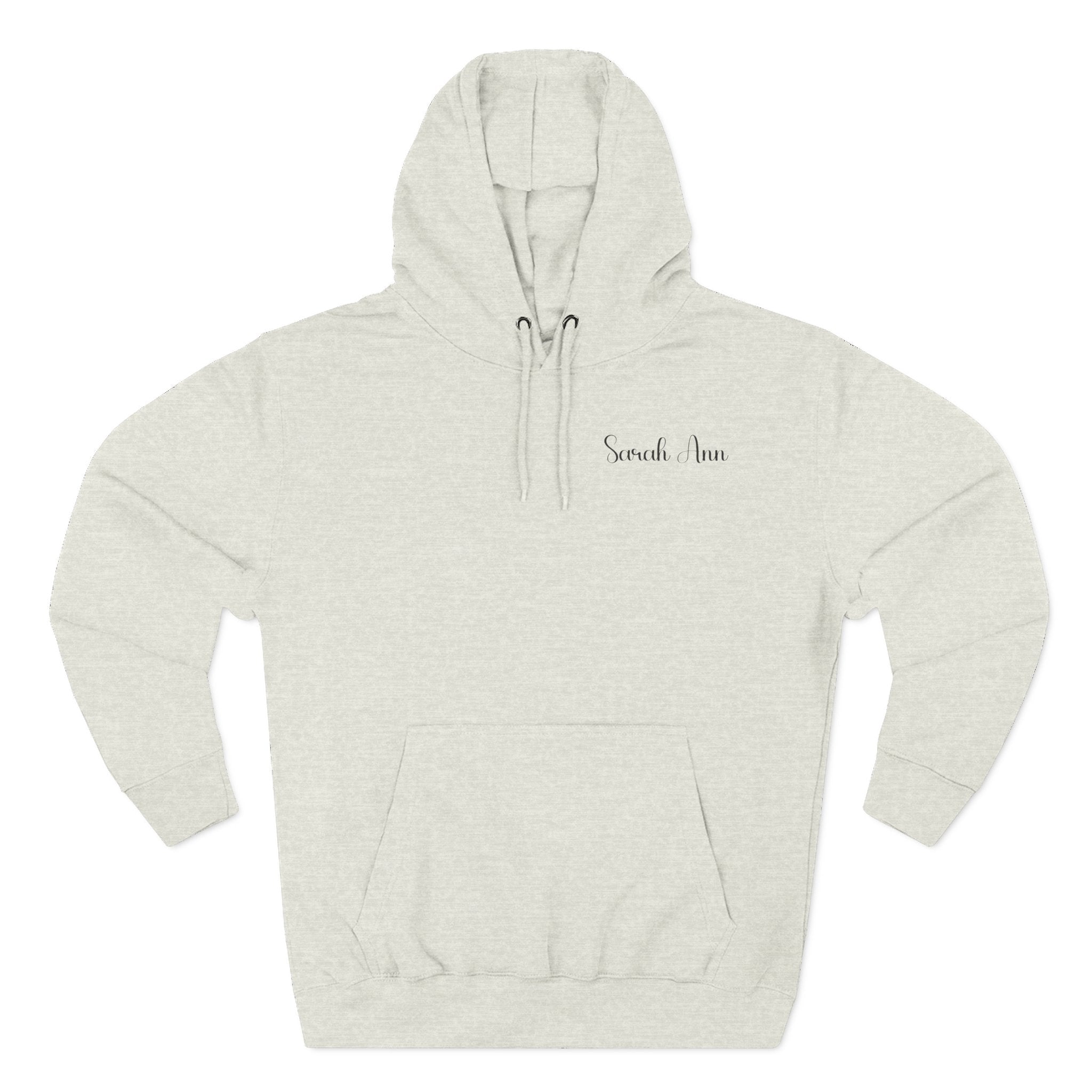 Front view of the personalized hoodie printed with "Peace Begins with a Cup of Tea" and embroidered name oatmeal heather