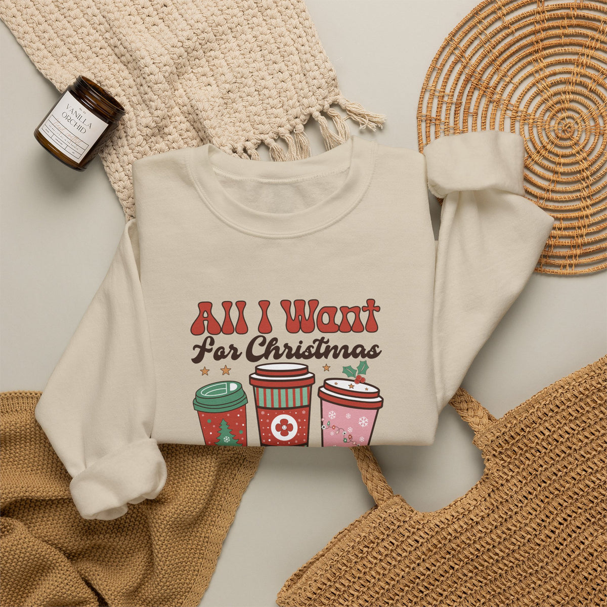 Sand personalized More Coffee Christmas sweatshirt, flat lay with cozy knit blanket