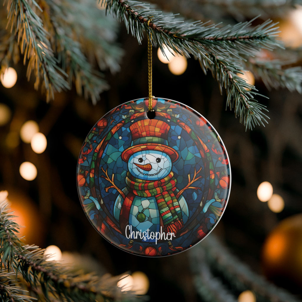 Custom mosaic snowman name ornament on pine branches with twinkling Christmas lights