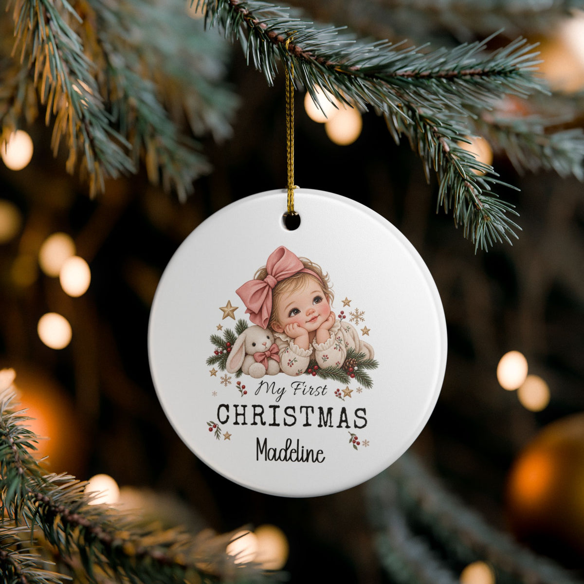 My First Christmas Baby Girl ornament hanging on a lit Christmas tree, lifestyle photo