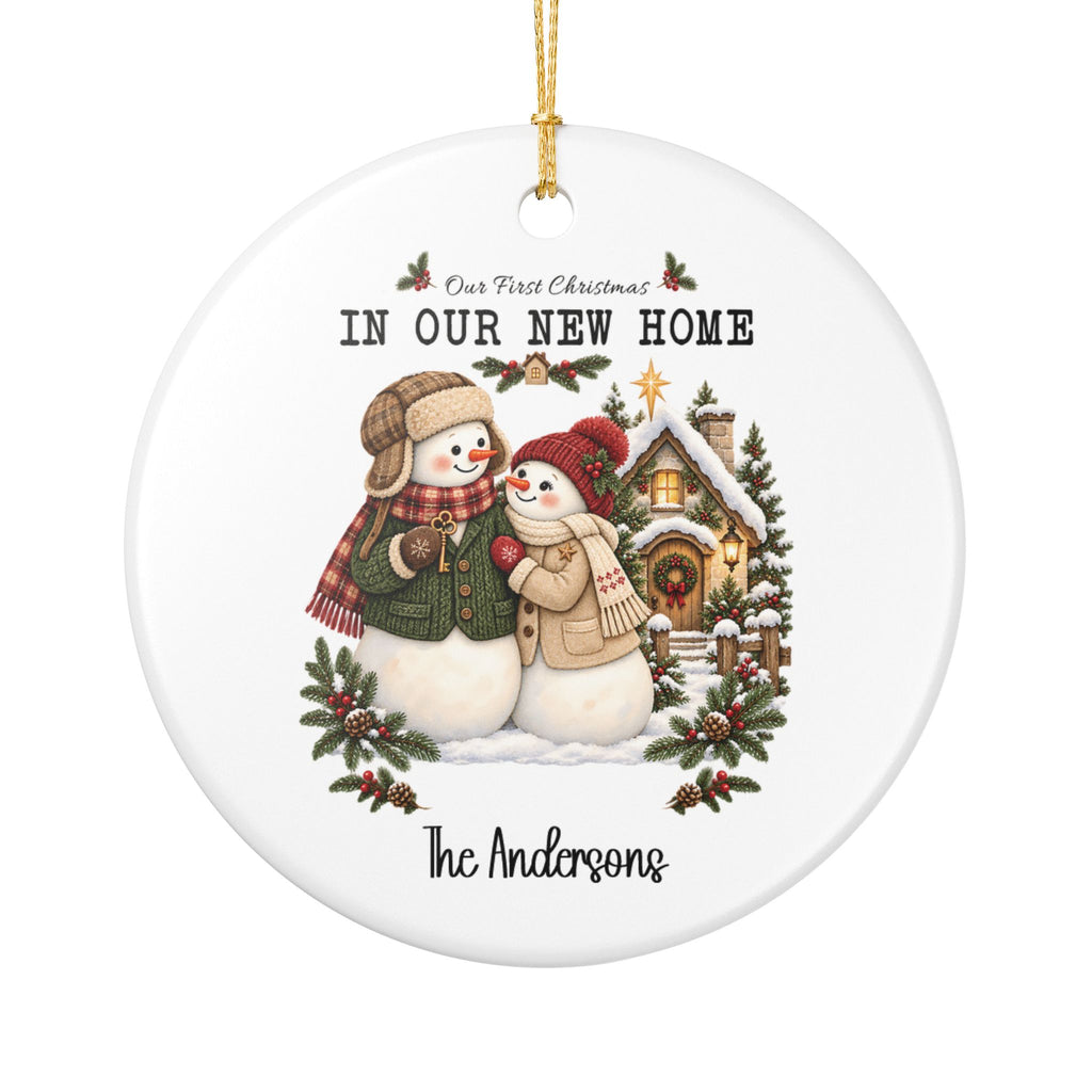 Personalized First Christmas in Our New Home ornament with a snowman couple beside a cozy snowy cottage, front view