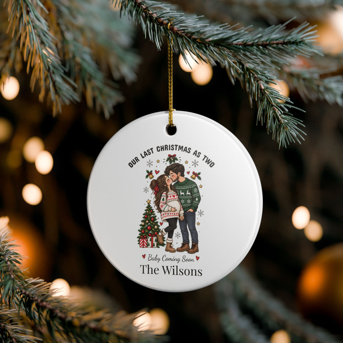 Personalized baby coming soon ornament hanging on a pine branch with soft bokeh lights