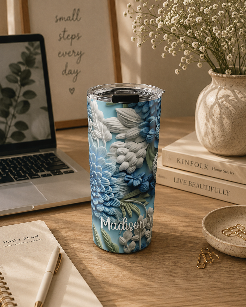 Personalized blue floral tumbler styled in a cozy lifestyle scene