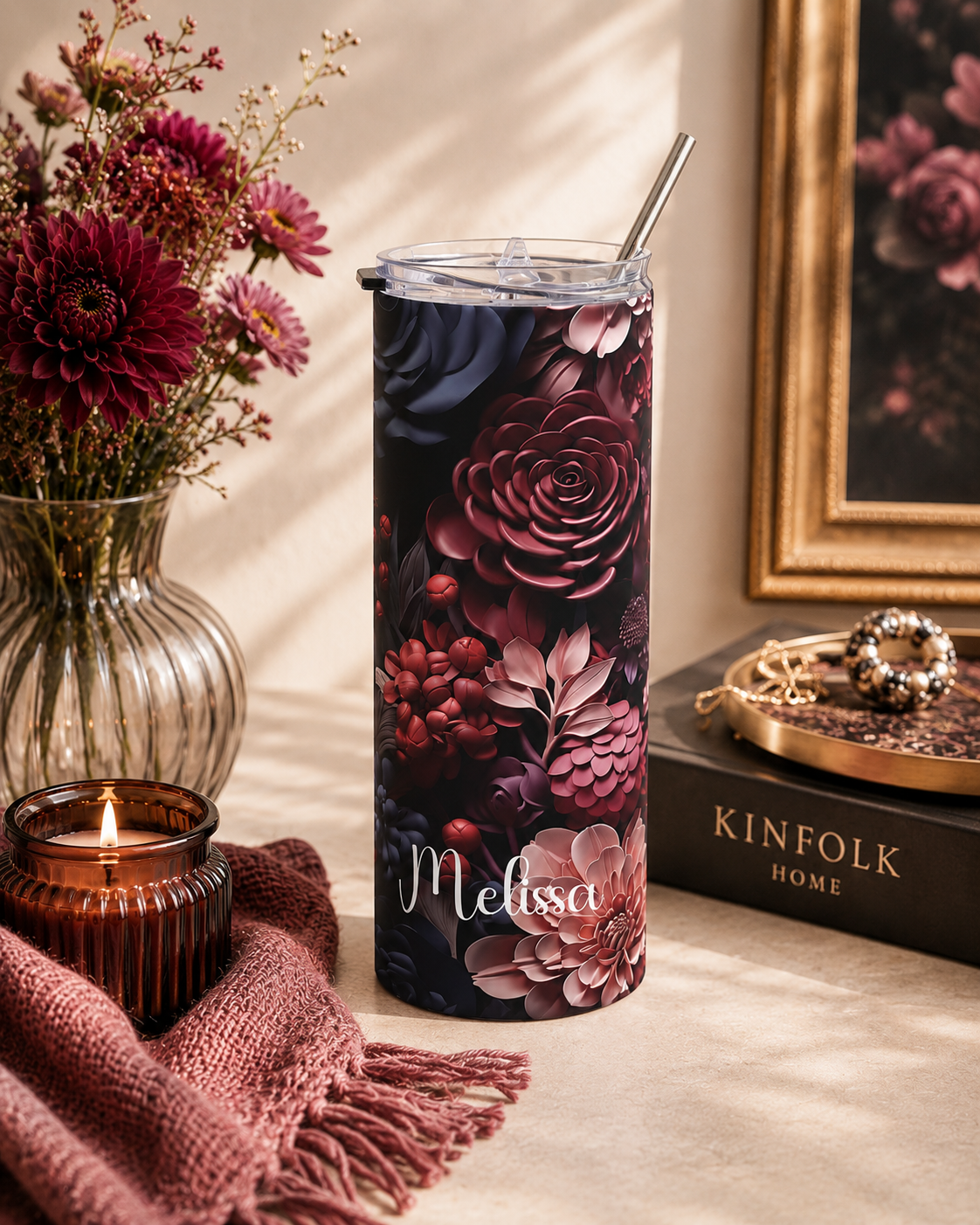 Dark floral skinny tumbler styled with elegant props in a lifestyle scene
