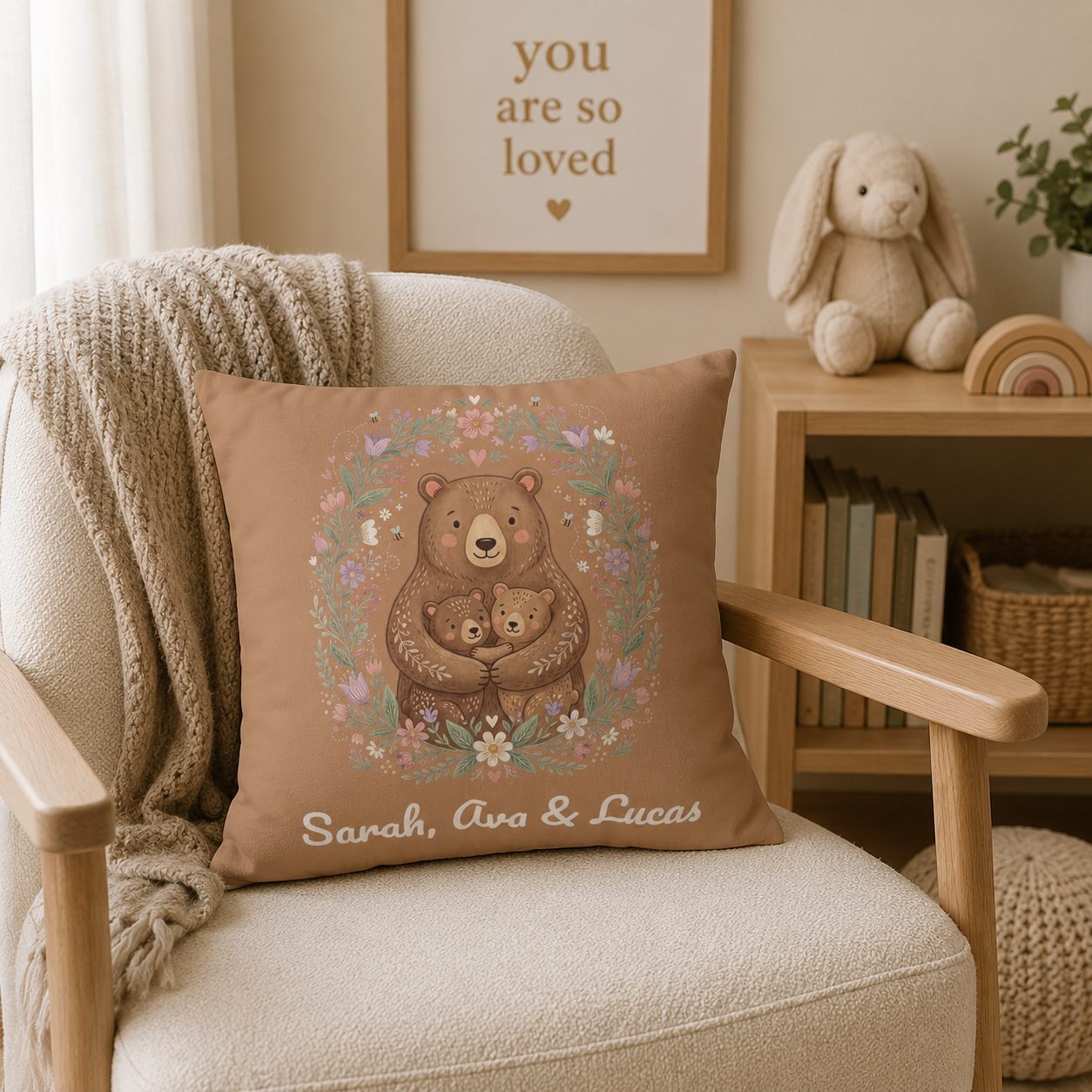 Personalized mama bear pillow design with an illustrated bear hugging two cubs in a floral wreath and three custom children's names