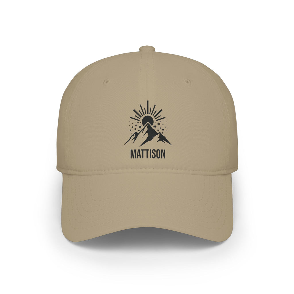 Khaki personalized mountain sunrise cap with bold mountain peak silhouette under a radiant rising sun and stars and the name Mattison, front view