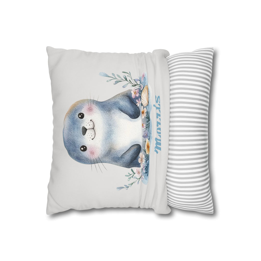 Baby seal name pillow styled on a nursery chair