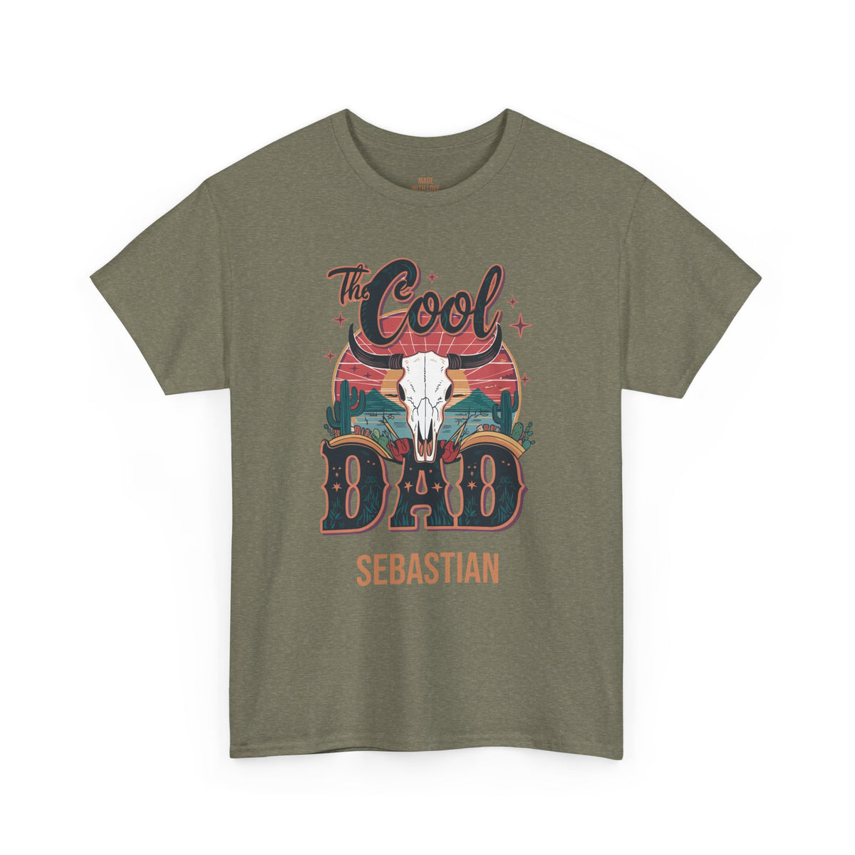 An olive green short-sleeve t-shirt with a western-themed graphic on the front. The graphic features a white bull skull, the words 'The Cool', 'DAD', and 'SEBASTIAN' in stylized lettering, and a sunset background.