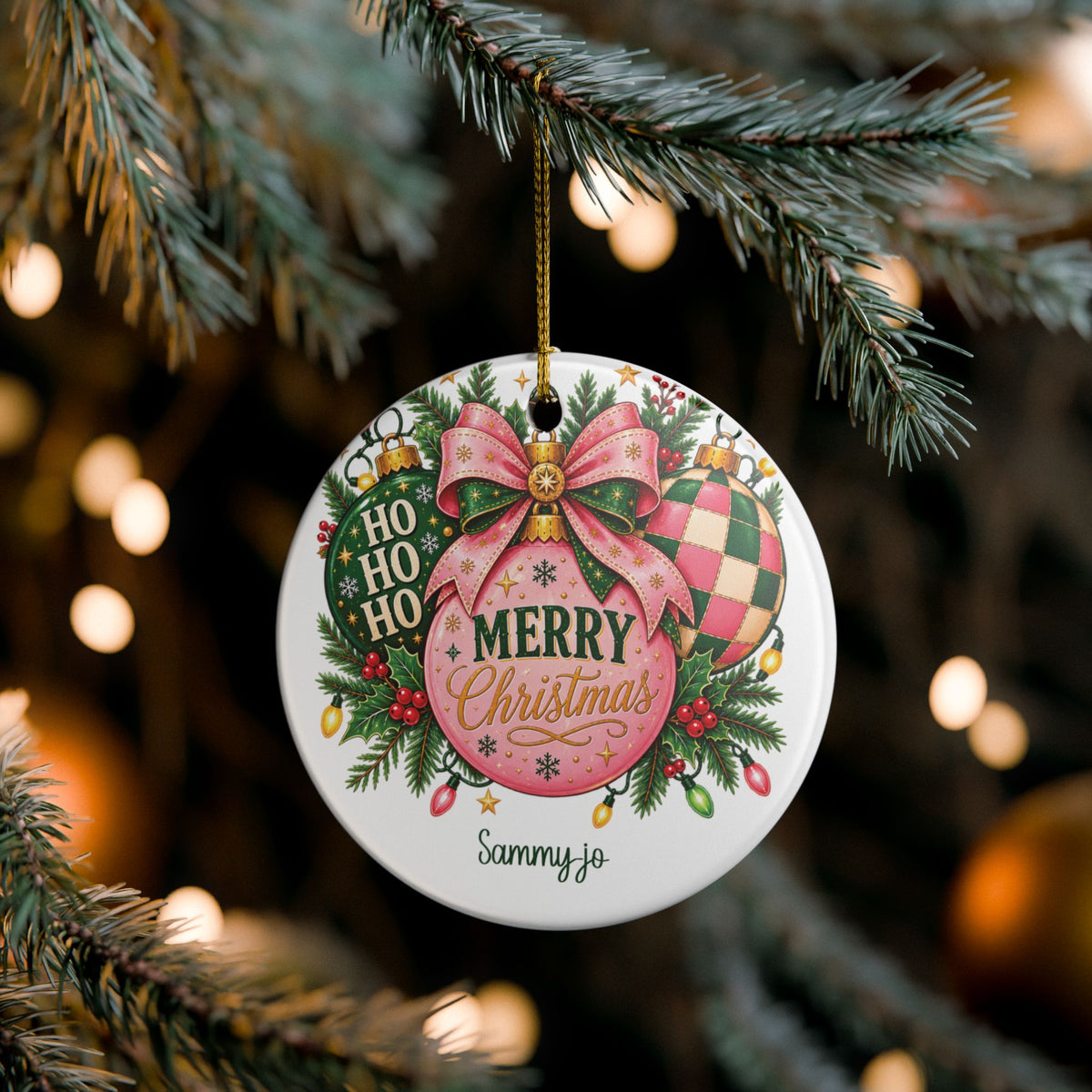 Pink Christmas Bow ornament hanging on a lit Christmas tree, lifestyle photo