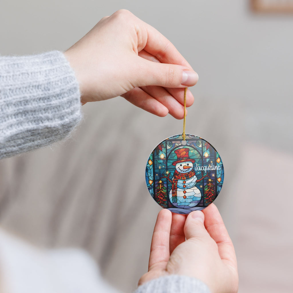 Hands holding the personalized Stained Glass Snowman ornament to show its size