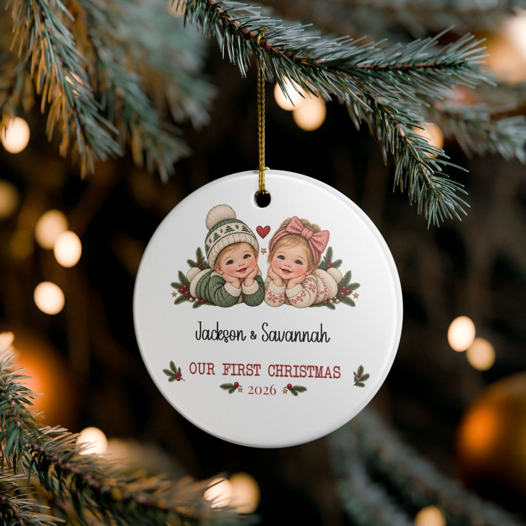 Custom twins first Christmas ornament on pine branches with twinkling Christmas lights