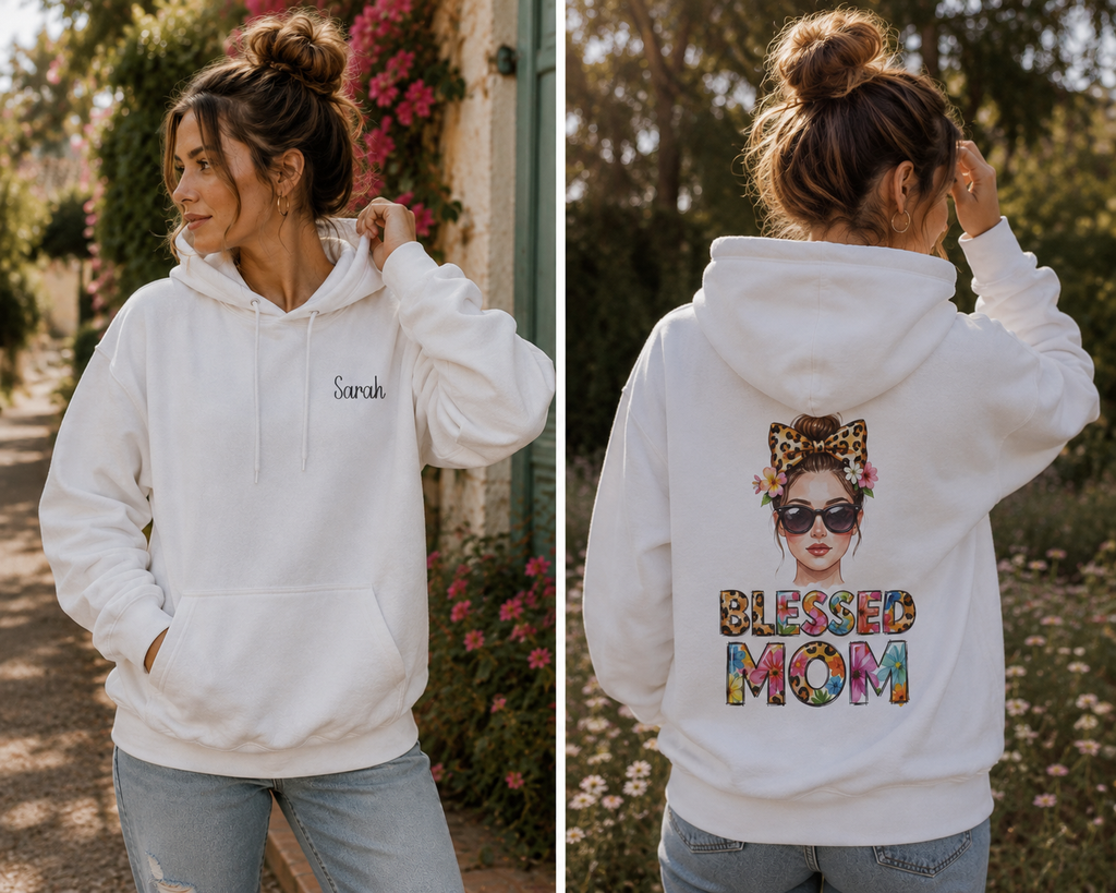 A split view showing a woman outdoors wearing a white hoodie from the front and back. The front has a small script logo on the left chest, and the back has a large colorful graphic of a woman with sunglasses and the words 'BLESSED MOM' in multicolored letters. For mom.
