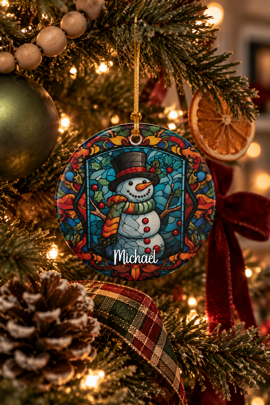 Personalized Woodland Stained Glass Snowman ornament on a decorated Christmas tree with red ribbon and warm lights, lifestyle photo