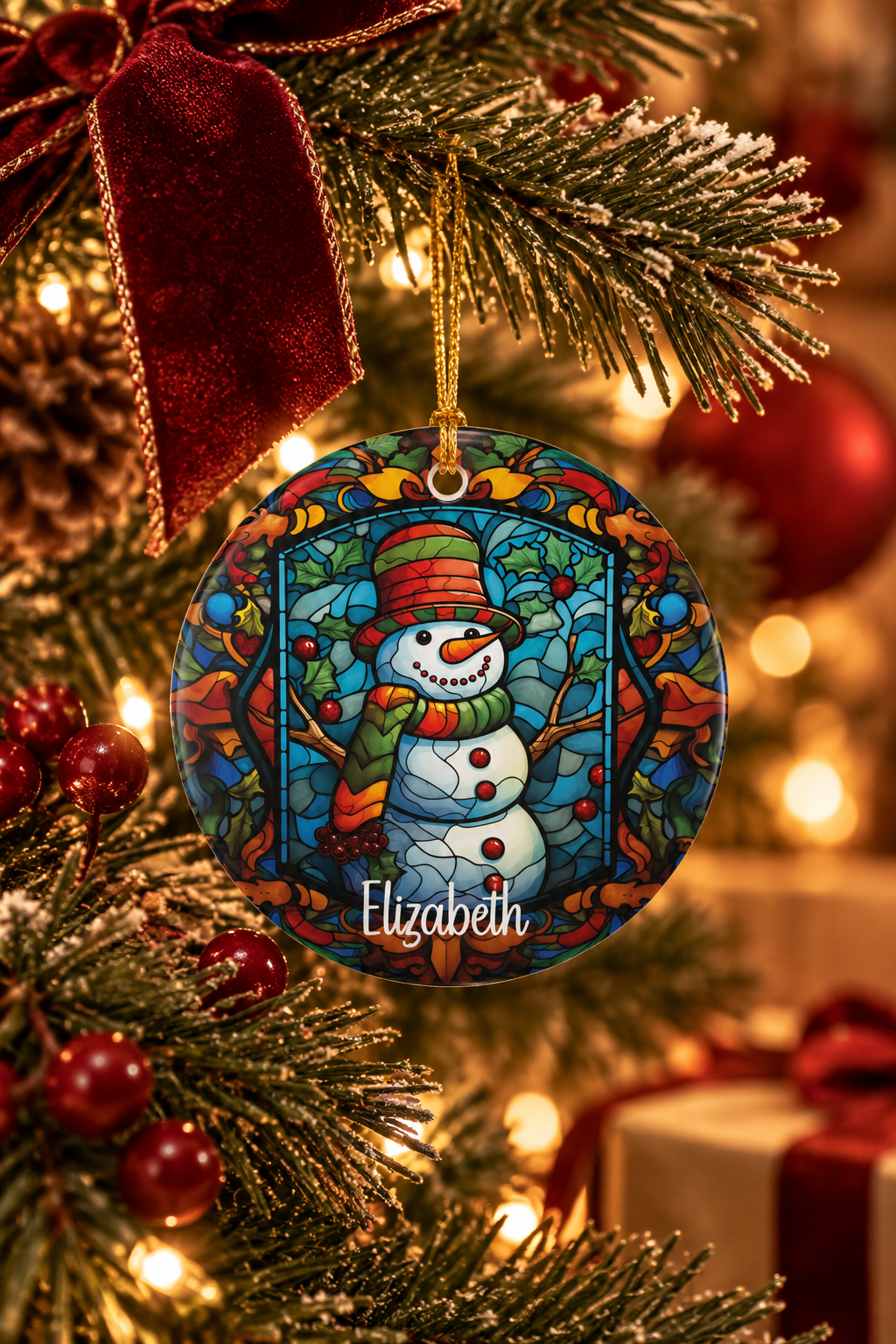 Woodland Stained Glass Snowman ornament close-up among gold baubles and pine on a festive Christmas tree